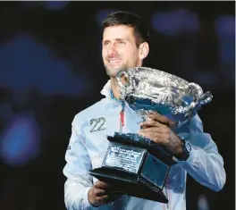  ?? MARTIN KEEP/GETTY ?? Serbia’s Novak Djokovic celebrates following his victory against Stefanos Tsitsipas in the Australian Open men’s final on Sunday.