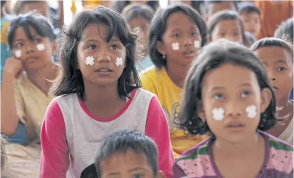  ?? REUTERS ?? Children attend a class at a camp for displaced people yesterday following the earthquake and tsunami in Palu.