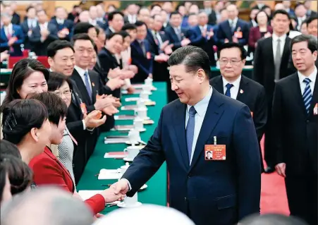  ?? XIE HUANCHI / XINHUA ?? President Xi Jinping extends greetings for Internatio­nal Women’s Day to deputies of the National People’s Congress during his visit to the Henan delegation in Beijing on Friday.