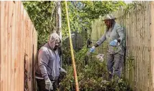  ?? Sahar Coston-Hardy/New York Times ?? Mary Felder and neighbor Quinzel Miller clean the alley behind the home in Philadelph­ia where Felder lives by herself.