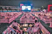  ?? AFP ?? People watch a film in distanced, private pods in Hong Kong.