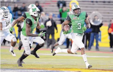  ?? JIM THOMPSON/JOURNAL ?? Marshall’s Tyler King (3) breaks away from Colorado State’s defense on a 90-yard touchdown run during Saturday’s Gildan New Mexico Bowl. The Thundering Herd held on for a 31-28 victory.