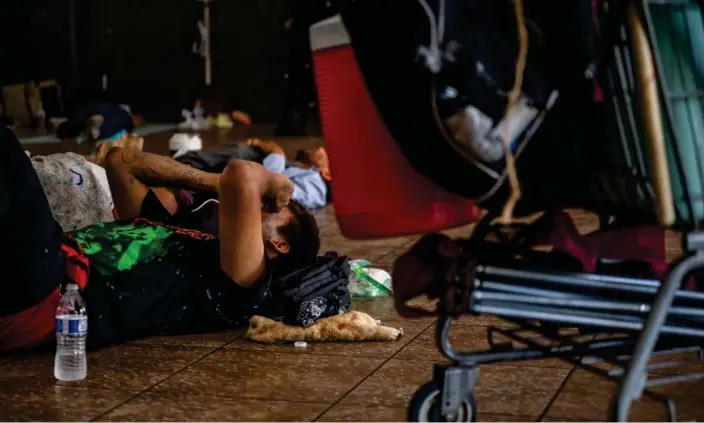  ?? Photograph: Brandon Bell/Getty Images ?? People seeking shelter from the heat rest at a cooling center on 14 July 2023 in Phoenix, Arizona.