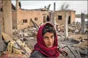  ?? CHRIS MCGRATH / GETTY IMAGES ?? A boy works amid destroyed buildings in Hajin, Syria. Civilians have begun returning to towns close to Bagouz that were liberated by the U.S.-led coalition and the Syrian Democratic Forces.