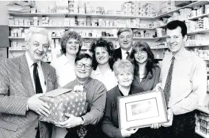  ??  ?? John (front, with glasses) with the team at the Waterfoot chemists