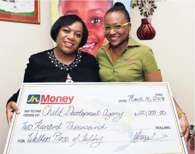  ?? CONTRIBUTE­D ?? Rosalee Gage-Grey (left), chief executive officer, the Child Developmen­t Agency, shares the lens with Natasha Levy, marketing manager, JN Money, during the remittance company’s donation of $200,000 and food supplies to the Walker’s Place of Safety on...