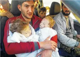  ?? ASSOCIATED PRESS FILE PHOTO ?? Abdel Hameed Alyousef, 29, holds his twin babies who were killed during a suspected chemical weapons attack in Khan Sheikhoun in the northern province of Idlib, Syria.