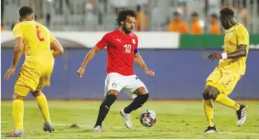  ?? Reuters ?? ↑ Egypt’s Mohamed Salah in action with Guinea’s players during their friendly match in Alexandria on Sunday.