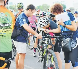  ??  ?? TELITI: Leon (dua kiri) dan penolongny­a Mrtle Patricia (kanan) memeriksa basikal salah seorang peserta yang mengikuti ujian di Sibu baru-baru ini.