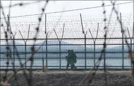  ?? AHN YOUNG-JOON — THE ASSOCIATED PRESS ?? South Korean army soldiers patrol along the barbed-wire fence in Paju, South Korea, near the border with North Korea on Thursday.
