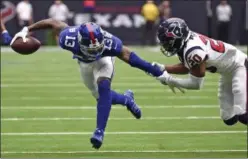  ?? ERIC CHRISTIAN SMITH - THE ASSOCIATED PRESS ?? Houston Texans defensive back Justin Reid (20) grabs the arm of New York Giants wide receiver Odell Beckham Jr. (13) during the first half of an NFL football game Sunday, in Houston.