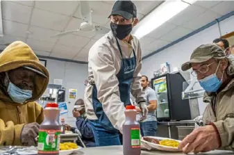  ?? Steph Chambers/Post-Gazette ?? Pirates bench coach Don Kelly serves meals Friday at Light of Life Rescue Mission on the North Side. “It’s something that’s always been important to us, to be able to give back in that way,” Kelly, a Mt. Lebanon native, said of himself and his wife, Carrie.