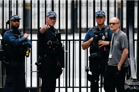  ?? (EPA) ?? The PM’s chief adviser, right, has expressed frustratio­n with the way Britain runs its security policies