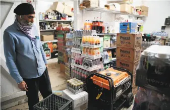  ?? Ramin Rahimian / Special to The Chronicle ?? Manager Gormeet “Monty” Singh shows off his generator at Calistoga Liquor in Calistoga. Singh says he went days without power during the Glass Fire and 2017’ s Tubbs Fire.