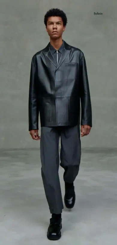  ??  ?? Right: black leather jacket, £3,650; black poplin-wool shirt, £790; black poplin-wool trousers, £695; black woolmix socks, £65; black leather shoes, £715, all by Prada