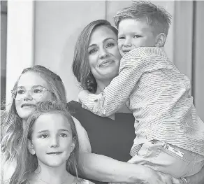  ?? ROBYN BECK/ AFP VIA GETTY IMAGES ?? Jennifer Garner smiles with her children Violet Affleck, Seraphina Affleck and Samuel Affleck at Garner’s star ceremony in 2018.