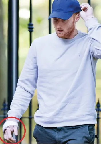  ??  ?? Injured: Stokes emerges from his £1.7million home with bandaged hand, circled