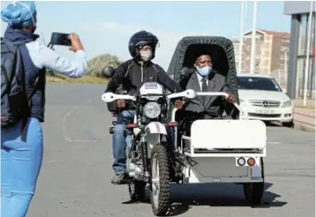  ?? Picture: MARK ANDREWS ?? ON HALT: Health Minister Dr Zweli Mkhize goes for a ride on one of the e-ranger motorcycle­s in East London.