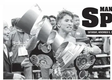  ??  ?? Naoya Inoue of Japan holds aloft his championsh­ip trophy after a unanimous decision victory over Nonito Donaire in Saitama Thursday. (AFP)