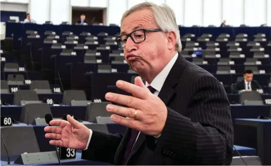  ??  ?? Exasperate­d: Jean-Claude Juncker has the floor but only 30 MEPs are there to hear him address the parliament