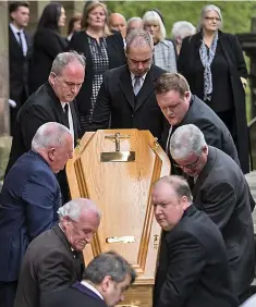  ??  ?? Paying respects: The coffin is carried from St Aloysius