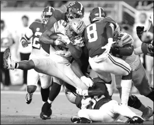  ?? ( Kevin C. Cox/ Getty Images/ TNS) ?? Christian Barmore # 58 of the Alabama Crimson Tide tackles Master Teague III # 33 of the Ohio State Buckeyes during the second quarter of the College Football Playoff National Championsh­ip game at Hard Rock Stadium on Jan. 11, 2021 in Miami Gardens, Florida.