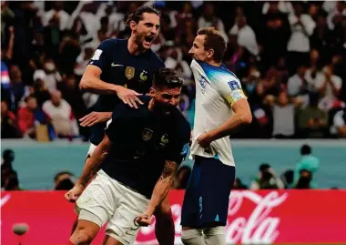  ?? Frank Augstein/Associated Press ?? France's Raphael Varane, top, and Olivier Giroud rejoice after England star Harry Kane missed high on a second-half penalty kick that would have tied the score.