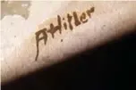  ??  ?? A picture shows the signature “AHitler” on a watercolou­r entitled “Im Wald” (In the forest) displayed at the Weidler auction house.