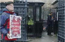  ??  ?? A pro-Brexit protester stands near Parliament in London, yesterday.