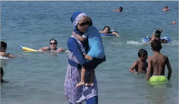  ?? Picture: REUTERS ?? A woman wearing a burkini in Marseille, a day after France suspended a ban on full-body burkini swimsuits that has outraged Muslims.