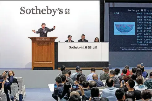  ?? PHOTOS PROVIDED TO CHINA DAILY ?? Henry Howard-Sneyd, Sotheby’s chairman of Asian Art, Europe and Americas, fields bids in Hong Kong in April.