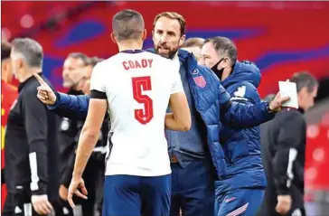  ?? AFP ?? England’s manager Gareth Southgate (centre) speaks with England’s defender Conor Coady during the internatio­nal friendly football match between England and Wales on October 8.