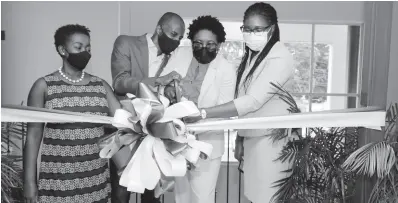  ?? PHOTO BY ASHLEY ANGUIN ?? From left: Gloria Henry, director, Montego Bay Chamber of Commerce; Lloyd Distant, president, Jamaica Chamber of Commerce; Janet Silvera, president, Montego Bay Chamber of Commerce; and Karlene Maye, vicepresid­ent, Montego Bay Chamber of Commerce cut the ribbon to officially open the Montego Bay Chamber of Commerce and Industry’s new office in Fairview, Montego Bay, yesterday.