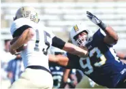  ?? STAFF PHOTO ?? UTC defensive lineman Keionta Davis, right, tackles Wofford quarterbac­k Michael Weimer during their game Nov. 8, 2014, at Finley Stadium.