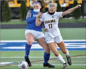  ?? DAN FENNER — FOR MEDIANEWS GROUP ?? Rochester Adams’ Lindsay Bower, right, and Rochester’s Nicole Miller jostle for possession of the ball in an OAA game Tuesday. Rochester came away with a 2-1win.