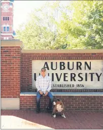  ?? COURTESY OF CHARLIE BRANNICK ?? Luigi sits with his owner Charlie Brannick during a stop at Auburn University in Auburn, Alabama.