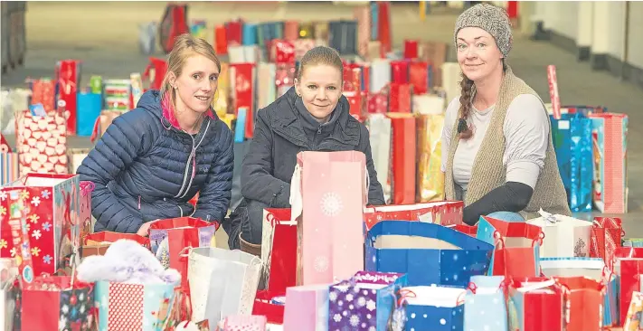  ?? Picture: Steven Brown. ?? From left: Charlotte Lever, Kate Hope and Hillary Haman with donations handed in to the Gift of Christmas Appeal.