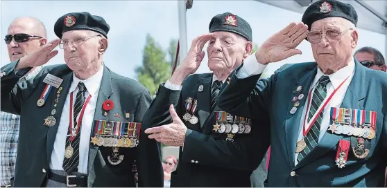  ?? CATHIE COWARD THE HAMILTON SPECTATOR ?? In 2015, Dieppe veterans Jack McFarland, Fred Engelbrech­t and Ken Curry salute during the playing of the national anthem and “God Save the Queen.”