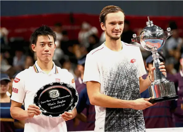  ??  ?? Vanquished and victor: Japan Open men’s singles champion Daniil Medvedev (right) posing with Kei Nishikori after their showdown in Tokyo yesterday. Medvedev won 6-2, 6-4. — Reuters