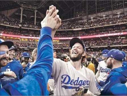  ?? Wally Skalij Los Angeles Times ?? CLAYTON KERSHAW was certainly happy after the Dodgers won Game 7 of the the National League Championsh­ip Series in Milwaukee, but a World Series title still eludes him. He said Friday that family and the good chance to win a crown kept him in L.A.