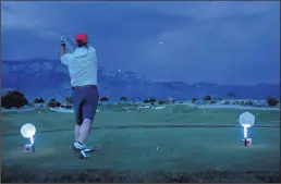  ?? DEAN HANSON/JOURNAL ?? Brain Schwartz tees off during the night golf outing at Sandia Golf Club last month.