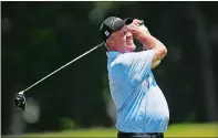  ?? SEAN D. ELLIOT/THE DAY ?? Norwich native John Elliott watches his drive on the 10th hole during the opening round of the Connecticu­t Senior Open. Elliott is tied for seventh at even-par.