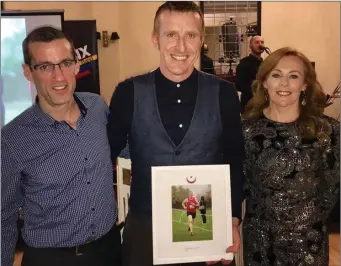  ??  ?? Kieran McGrath receives his Drogheda &amp; District AC Male Sport Star of the Year award from Aonghus O’Connor and Ciara O’Reilly.