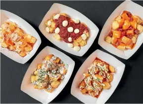  ?? SUPPLIED ?? Fried potatoes come with various toppings at Mercado Little Spain. If you’re in a group, you’ll be able to try them all.