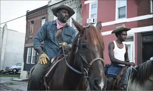  ??  ?? This image provided by Netflix shows Idris Elba, left, and Caleb McLaughlin in a scene from the film “Concrete Cowboy,” premiered April 2on Netflix.