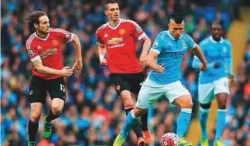  ?? Rex Features ?? Sergio Aguero of Manchester City plots a move against Manchester United during a Premier League clash. The clubs are to meet for the first time outside Britain during the pre-season.