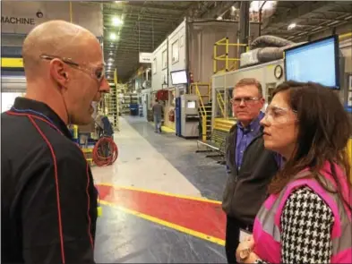  ?? PAUL POST — PPOST@DIGITALFIR­STMEDIA.COM ?? Operations Manager Ron Zimmerman, left, explains production processes to U.S. Rep. Elise Stefanik, R-Willsboro, right, during a tour of the Hollingswo­rth & Vose company’s Easton plant on Tuesday. Plant Manager Stacey Campbell, center, looks on.