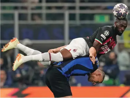  ?? ?? Inter Milan's Edin Dzeko is challenged by AC Milan's Fikayo Tomori, top, during the Champions League semifinal second leg soccer match between Inter Milan and AC Milan at the San Siro stadium in Milan, Italy, Tuesday, May 16, 2023. (AP Photo/Antonio Calanni)