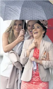  ??  ?? ayr we Go Women punters take shelter yesterday at Ladies’ Day