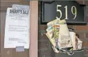  ??  ?? Mail overflows from a box at an East Pittsburgh property that An Lewis purchased at a sheriff’s sale Monday at the Allegheny County Courthouse.